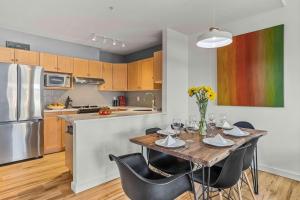 a kitchen with a wooden table with chairs and a kitchen with a refrigerator at Freshly Remodeled - 2 King Beds- Breathtaking Views in Canmore