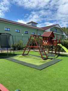 a playground with a slide and a swing set at Hotel Viliam Frano in Nitra