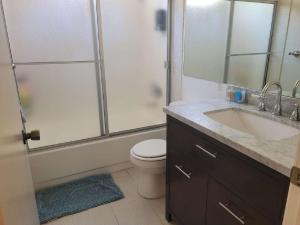 a bathroom with a shower and a toilet and a sink at 3BR & Loft near Palmdale Hospital- Shared Hm in Palmdale +17 photos