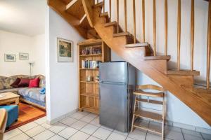 a kitchen with a refrigerator and a staircase at Haus Clara in Neßmersiel