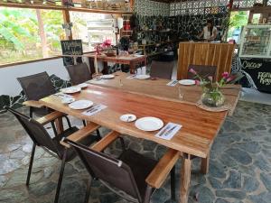 a large wooden table with chairs in a restaurant at El Paraiso de Carmen in Palomino +70 photos