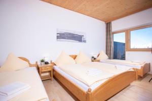 a room with two beds and a window at Alpenrelax Krepperhütte in Volders