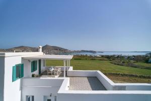 a white house with a view of the ocean at Two Bedroom Cycladic House With Sea View in Kampos Paros