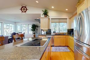 a kitchen with wooden cabinets and a refrigerator at The Ocean Dream in Rockaway Beach