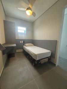 a bedroom with a bed and a ceiling fan at Joy Hotel in Sao Paulo +3 photos