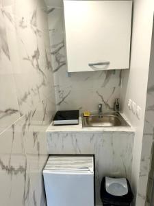 a small bathroom with a sink and a toilet at Appartement 1 - Orsay, France in Orsay