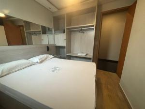 a large white bed in a small room at Joy Hotel in São Paulo