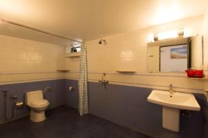 a bathroom with a toilet and a sink at Villa Baywalk Goa - 200 meters from Morjim Beach in Morjim