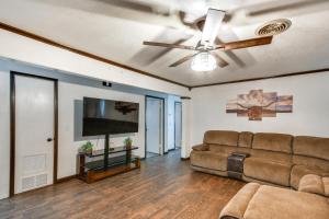 ein Wohnzimmer mit einer Couch und einem Deckenventilator in der Unterkunft Cozy Home with Fire Pit Drive to Palo Duro Canyon! in Amarillo