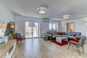 a living room with a couch and a table at Holiday home in Novi Vinodolski 45274 in Novi Vinodolski