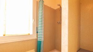 a shower with a blue and white shower curtain at Sardinianworld - Otton House in Oristano +21 photos