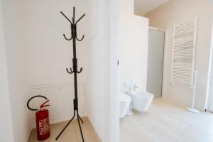 a white bathroom with a fire extinguisher in a room at The Moon in Monopoli +58 photos
