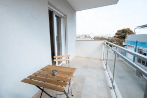a wooden bench sitting on top of a balcony at The Moon in Monopoli