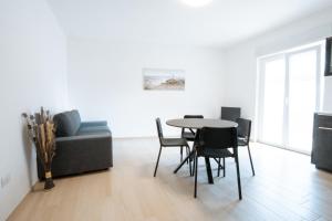 a living room with a table and chairs and a couch at The Moon in Monopoli