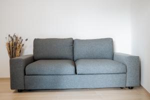 a blue couch sitting in a living room at The Moon in Monopoli