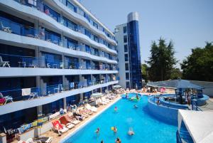 a swimming pool in front of a hotel at Aphrodite Hotel in Golden Sands