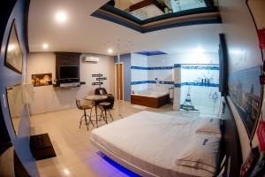 a bedroom with a bed and a table in a room at Motel Nix in Santa Maria