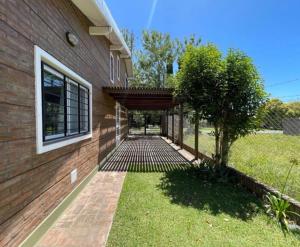 a house with a brick walkway next to a building at Casa en Pueblo Esther in General Lagos +1 photo