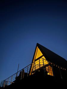 a house with a yellow facade with a blue sky at Áčko in Oščadnica