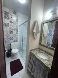 a bathroom with a sink and a toilet and a shower at Pousada Green in Florianópolis +41 photos