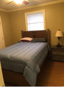 a bedroom with a bed with a laptop on it at 3 bedroom Cozy vacation rental near airport in Kenner