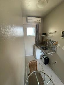 a small bathroom with a sink and a counter at Pousada Green in Florianópolis