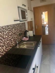a kitchen with a sink and a counter top at Apartment "Birgit" Sonnleitn/Nassfeld in Sonnenalpe Nassfeld