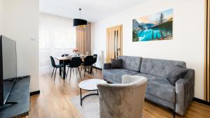 a living room with a couch and a table at Apartament Komfort Lux in Karpacz