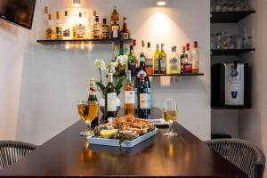 a table with a tray of food and wine glasses at Best Western Hôtel Royan Océan in Royan