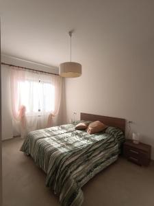 a bedroom with a bed and a window at Dimora Zaffiro in LʼAquila