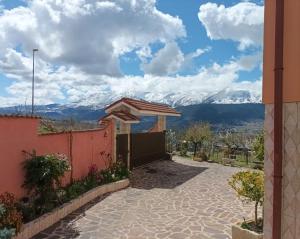 a house with a view of mountains at Dimora Zaffiro in LʼAquila