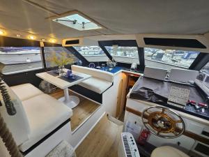 a view of the inside of a boat with a table at Rhapsody in Blue in Chertsey
