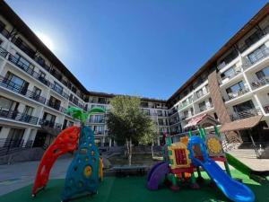 a playground in front of a apartment building at Bakuriani Haystack Apartment 219 Rooftop Views in Bakuriani