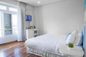 Ліжко або ліжка в номері Palmier Hotel - Art House Da Nang