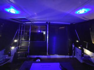 a room with blue lights and a ladder in it at Rhapsody in Blue in Chertsey