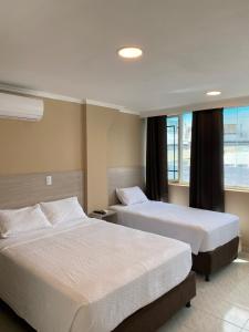 Postel nebo postele na pokoji v ubytování Holiday Sai Hotel