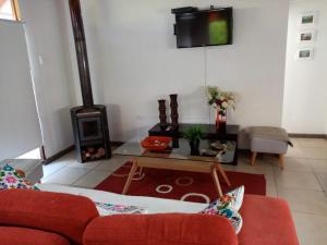 a living room with a couch and a wood stove at Casa Tunquen VIP in Tunquén