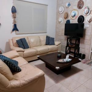 a living room with a couch and a coffee table at Danitsea villa with privat pool in Psematismenos