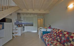 a living room with a couch and a kitchen at Casa Rita Fonteno in Fonteno +29 photos