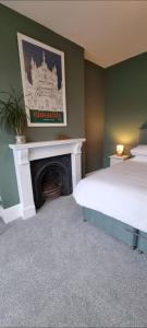 a bedroom with a bed and a fireplace at Time & Tide Town House in Seaford