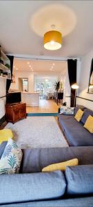 a living room with blue couches and a living room at Time & Tide Town House in Seaford +31 photos