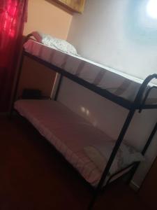 a bunk bed in a dark room with a bunk bedscribed at La casa de la ti in Lanús