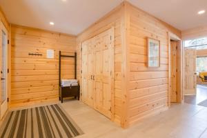 a sauna with wooden walls and a rug at Snow Pines by StayIn in Fernie