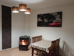 a dining room with a table and a stove at Casa rural Sabina in Montejaque