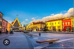 a town with yellow buildings and benches on a street at Na Podwalu in Jaworzno +10 photos