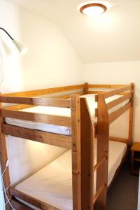 a couple of bunk beds in a room at Les Chalets De Superd Fraxinelle - 2 PIECES 4 PERSONNES EXPO SUD BALCON MAE-8724 in Le Dévoluy