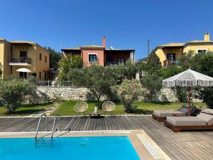 a swimming pool in front of a house at Alkyon Villas in Syvota