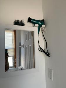 a blow dryer on a wall next to a mirror at 2265 Bruckner Blvd Apartments in Bronx