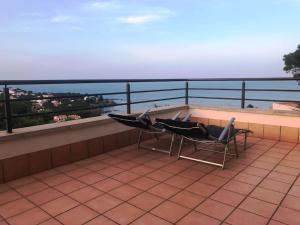 two chairs on a balcony with a view of the ocean at Sensational Apartment with panoramic views in Llança