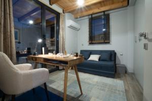 a living room with a blue couch and a wooden table at Endless View Orma Guesthouse in Orma